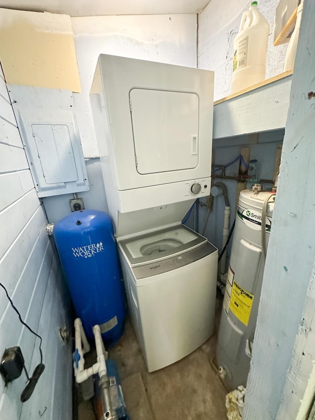 laundry area featuring electric water heater and stacked washing maching and dryer