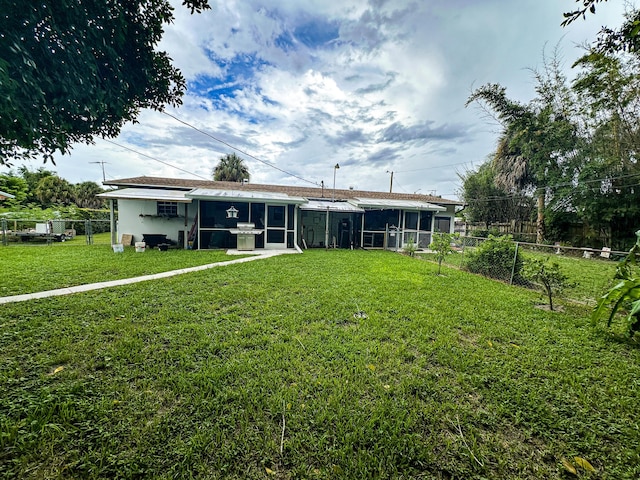 back of house with a lawn