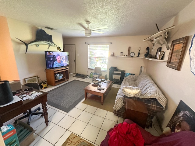 tiled living room featuring ceiling fan and a textured ceiling