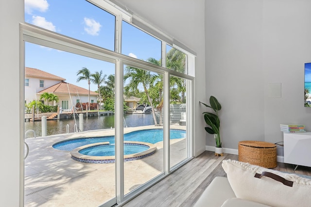 5533 Rico Dr, Boca Raton, FL 33487 - entryway featuring a water view, wood finished floors, and baseboards