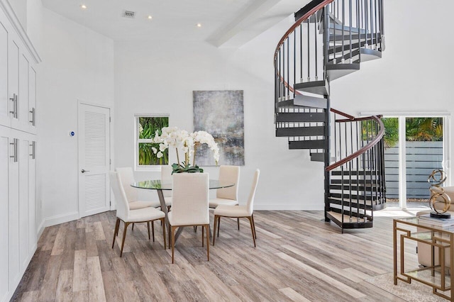 5533 Rico Dr, Boca Raton, FL 33487 - dining room with wood finished floors, stairway, a towering ceiling, baseboards, and recessed lighting