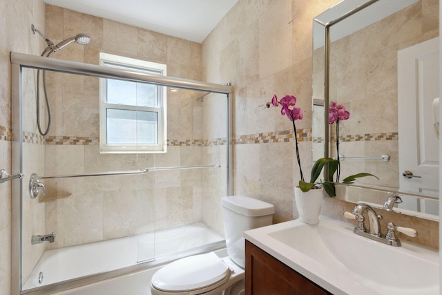 5533 Rico Dr, Boca Raton, FL 33487 - bathroom featuring tile walls, toilet, vanity, and enclosed tub / shower combo