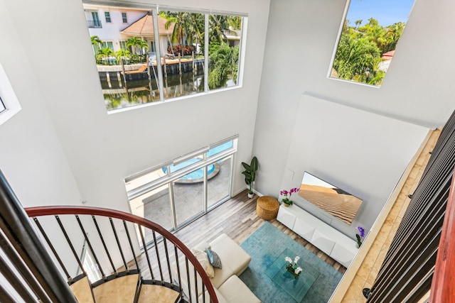 5533 Rico Dr, Boca Raton, FL 33487 - stairs featuring a towering ceiling, wood finished floors, and baseboards
