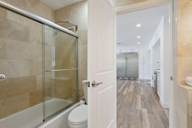 5533 Rico Dr, Boca Raton, FL 33487 - bathroom with wood finished floors, toilet, shower / bath combination with glass door, vanity, and recessed lighting