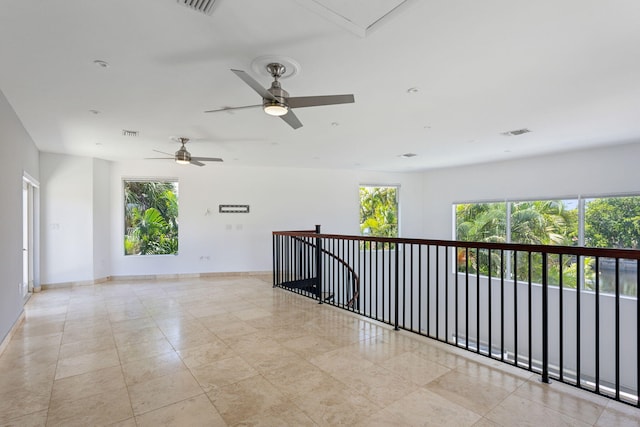 5533 Rico Dr, Boca Raton, FL 33487 - empty room featuring plenty of natural light, ceiling fan, baseboards, and attic access