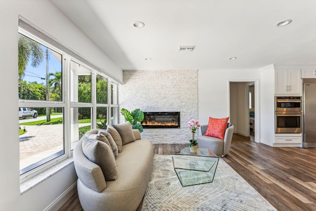 5533 Rico Dr, Boca Raton, FL 33487 - living area with a stone fireplace, dark wood-style floors, recessed lighting, and baseboards