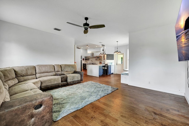 5890 NE 56th Pkwy, Okeechobee, FL 34972 - living area with visible vents, ceiling fan, baseboards, and dark wood-style floors