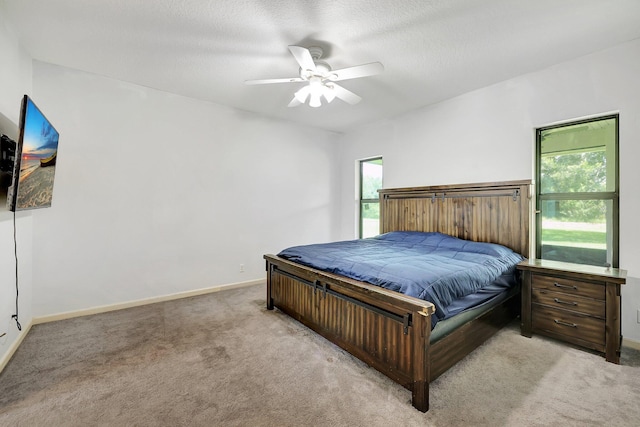 5890 NE 56th Pkwy, Okeechobee, FL 34972 - bedroom featuring baseboards, ceiling fan, and light carpet
