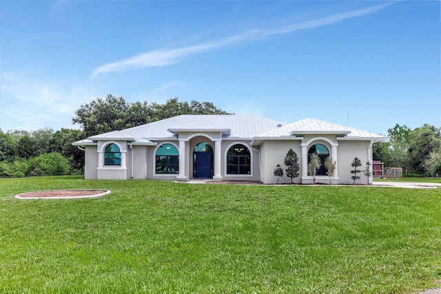 5890 NE 56th Pkwy, Okeechobee, FL 34972 - mediterranean / spanish-style house featuring a front yard and stucco siding
