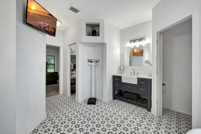 5890 NE 56th Pkwy, Okeechobee, FL 34972 - bathroom with tile patterned floors, baseboards, and visible vents