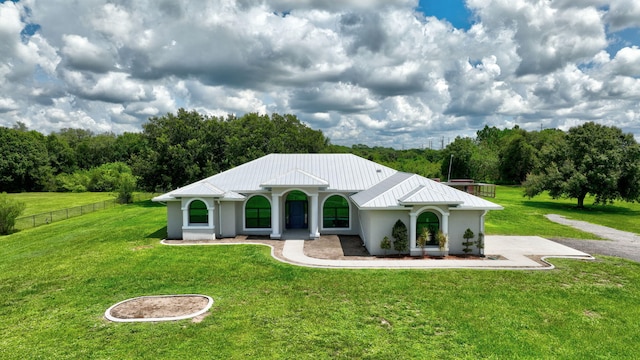 5890 NE 56th Pkwy, Okeechobee, FL 34972 - exterior space featuring metal roof, stucco siding, fence, and a front lawn