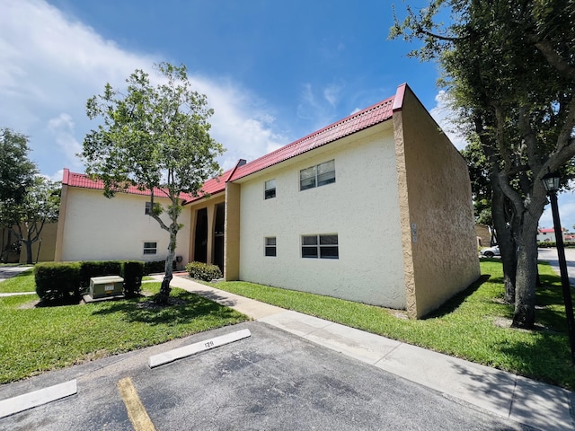 rear view of property featuring a lawn