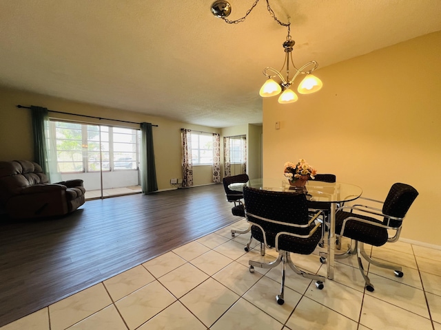 dining space with a chandelier and light hardwood / wood-style flooring