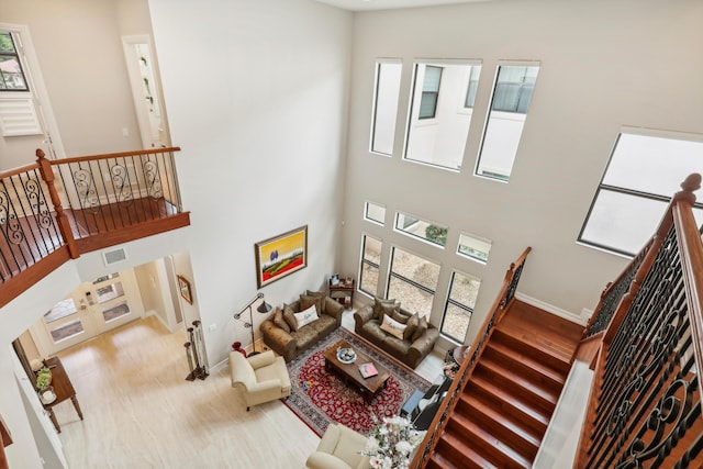 living room featuring a wealth of natural light and a high ceiling