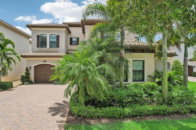 mediterranean / spanish house with a garage