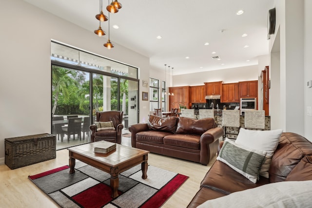 living room featuring sink and light hardwood / wood-style floors