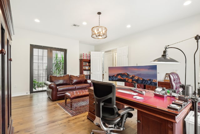 office space with a notable chandelier, light hardwood / wood-style flooring, and french doors