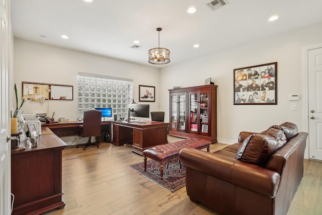 office area with a chandelier and light wood-type flooring