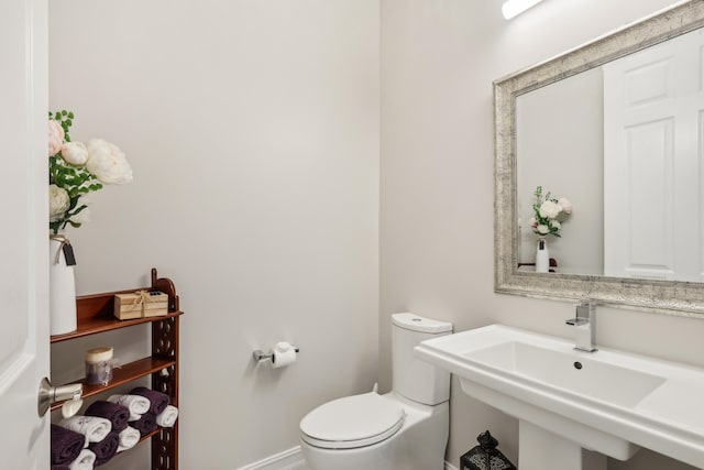 bathroom featuring toilet and sink