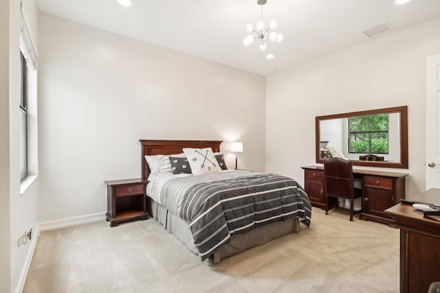 carpeted bedroom featuring an inviting chandelier