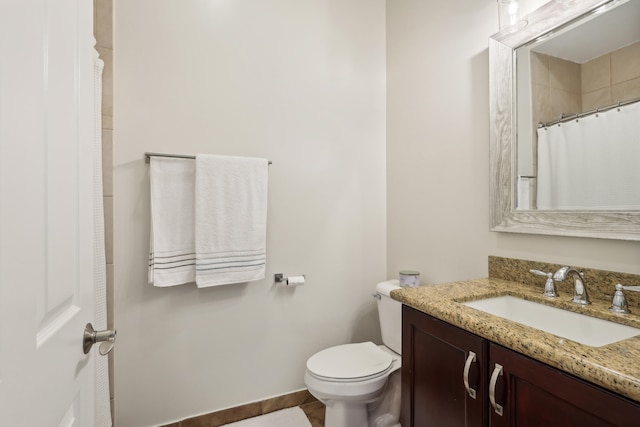 bathroom with tile patterned flooring, toilet, and vanity