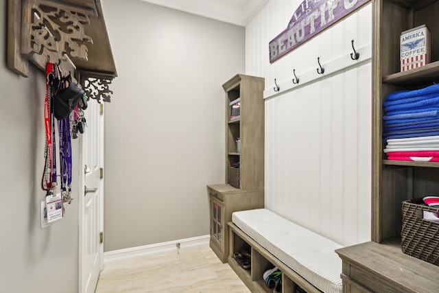 mudroom featuring crown molding and light wood-type flooring