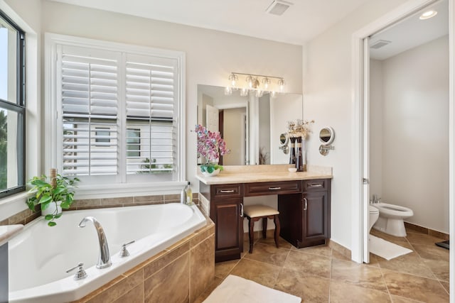 bathroom with vanity, a bidet, plenty of natural light, and tiled bath