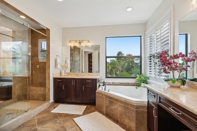 bathroom with tile patterned flooring, plus walk in shower, and vanity