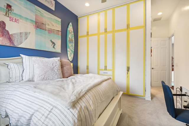 bedroom with light carpet and a closet