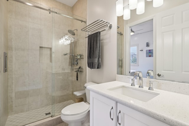 bathroom featuring vanity, an enclosed shower, ceiling fan, and toilet