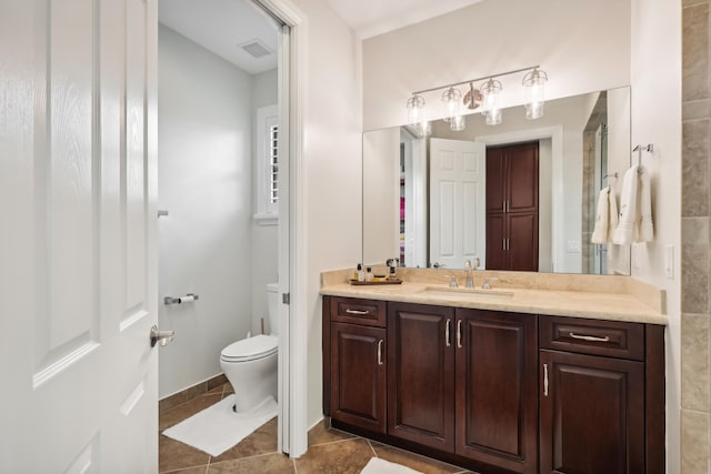 bathroom with vanity, tile patterned floors, and toilet