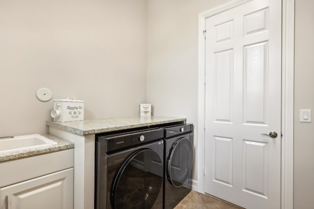 laundry area featuring washer and clothes dryer and light tile patterned floors