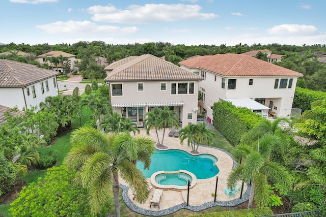 view of swimming pool with a patio and an in ground hot tub