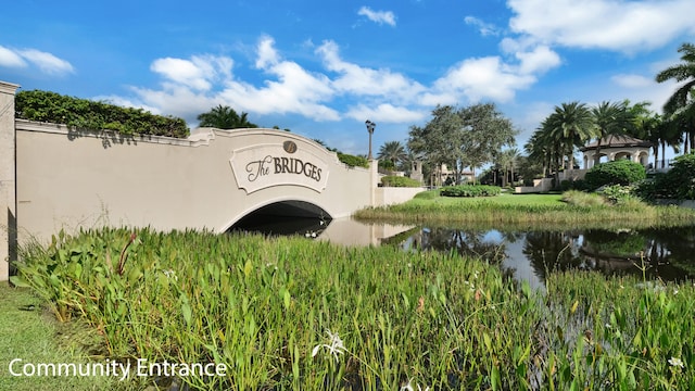 community / neighborhood sign featuring a water view