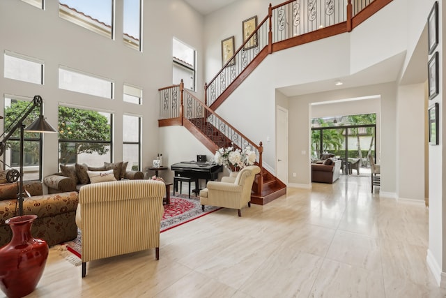 tiled living room featuring plenty of natural light and a high ceiling