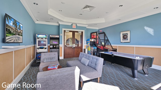 game room featuring dark colored carpet, crown molding, and a tray ceiling