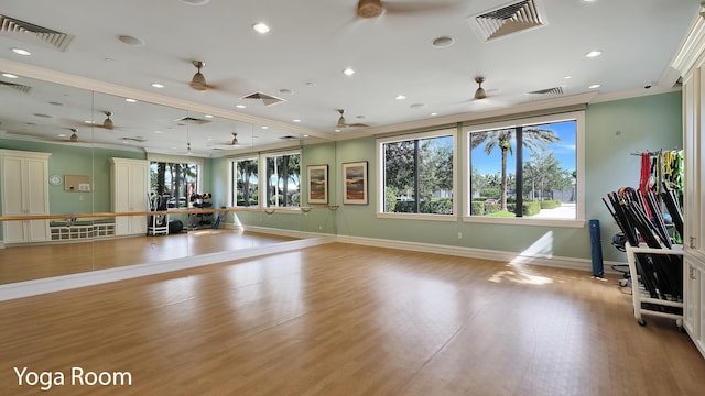 exercise area with ceiling fan, light hardwood / wood-style flooring, and ornamental molding