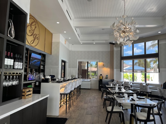 dining room with light hardwood / wood-style flooring, an inviting chandelier, and a towering ceiling