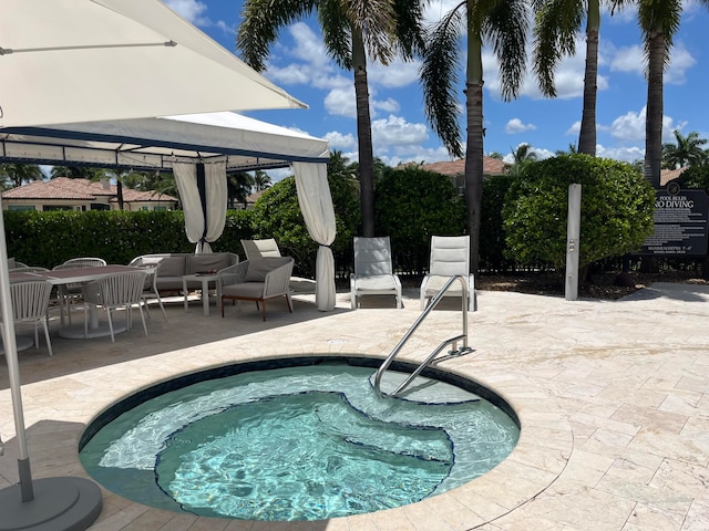 view of swimming pool with a patio and a community hot tub