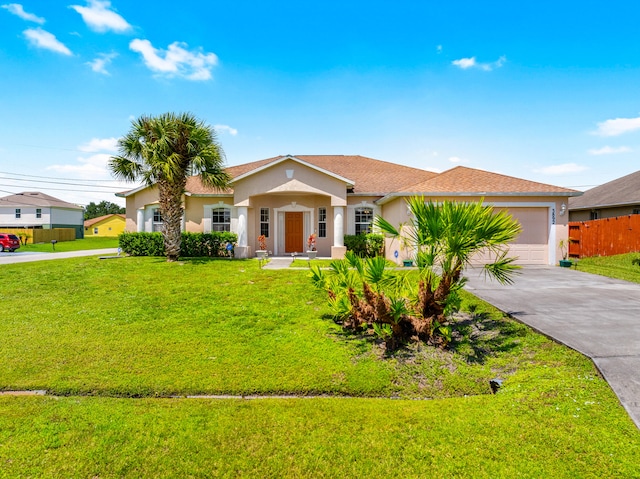 view of front of property featuring a garage and a front yard