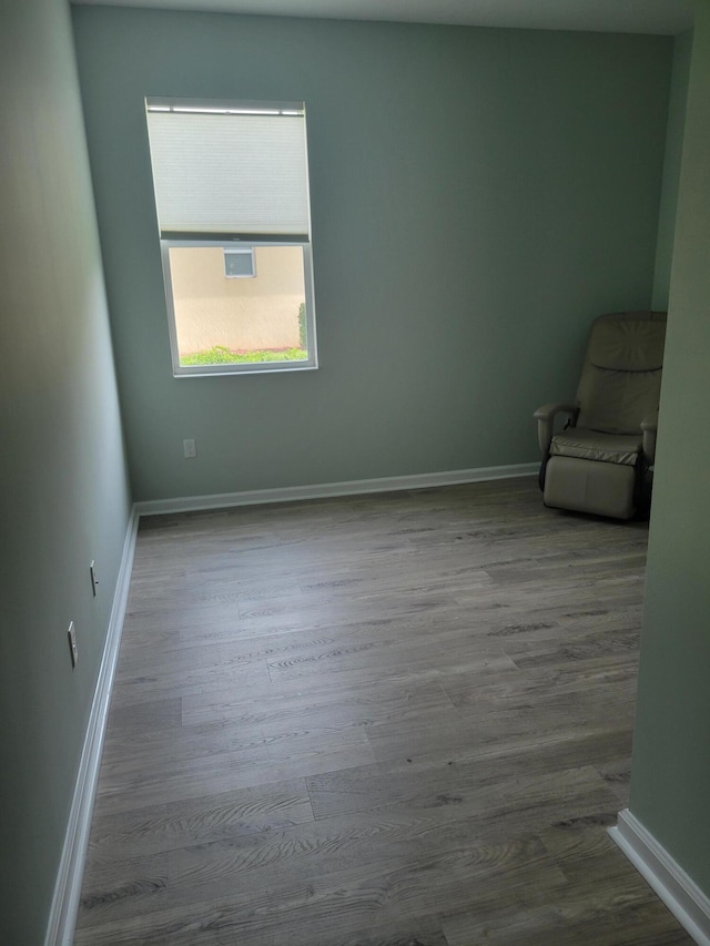 empty room with hardwood / wood-style floors