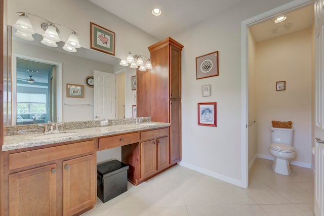 bathroom with tile patterned flooring, toilet, and dual bowl vanity