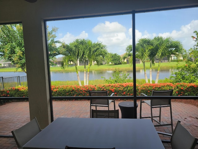 sunroom / solarium with a water view