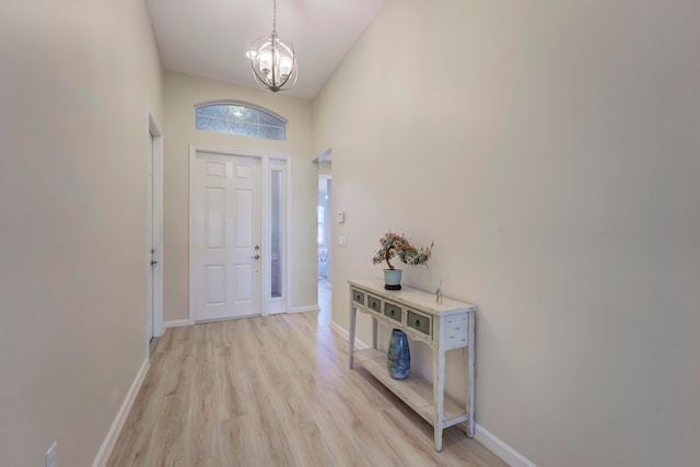 foyer entrance with an inviting chandelier and light wood-type flooring