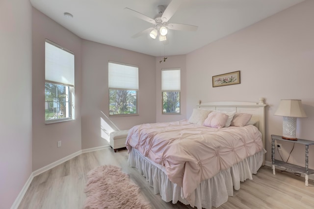 bedroom with light hardwood / wood-style floors and ceiling fan