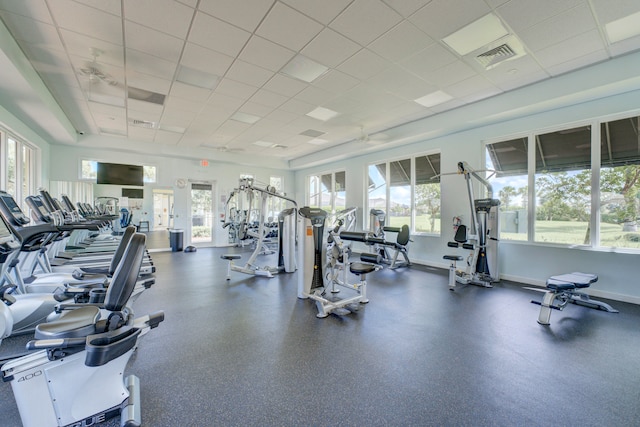 gym featuring a wealth of natural light and a paneled ceiling