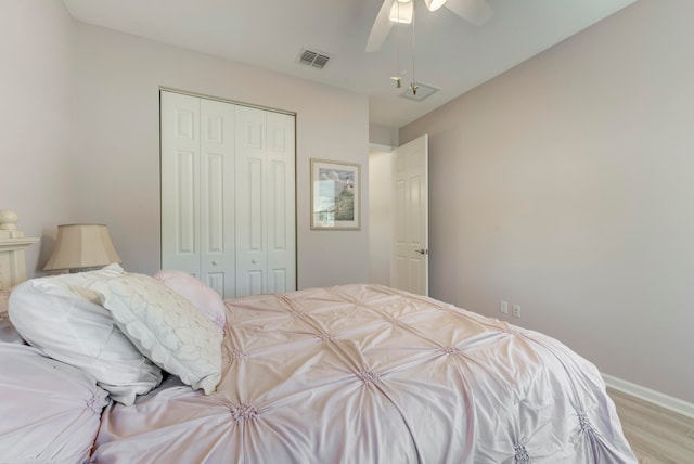 bedroom with hardwood / wood-style flooring, a closet, and ceiling fan