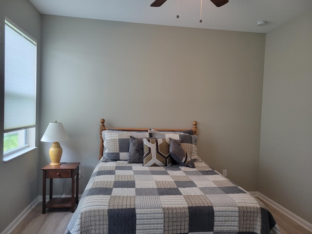 bedroom with wood-type flooring and ceiling fan