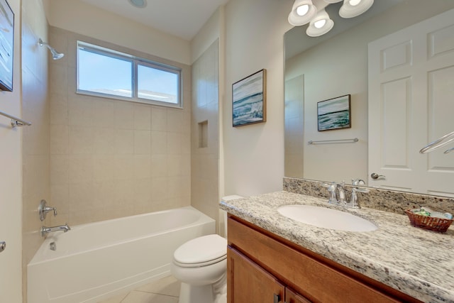 full bathroom with vanity, tile patterned flooring, tiled shower / bath, and toilet