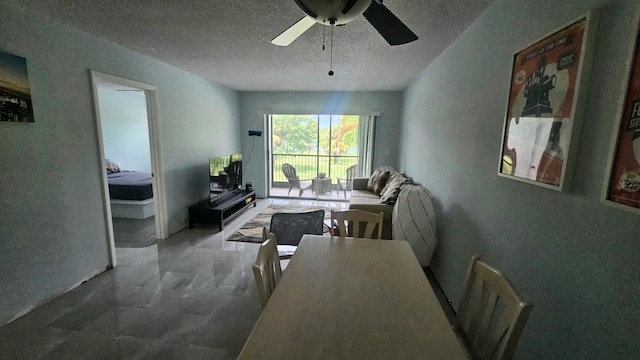 dining room featuring a textured ceiling and ceiling fan